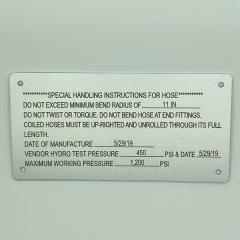 Metal plate etched with handling instructions for a hose